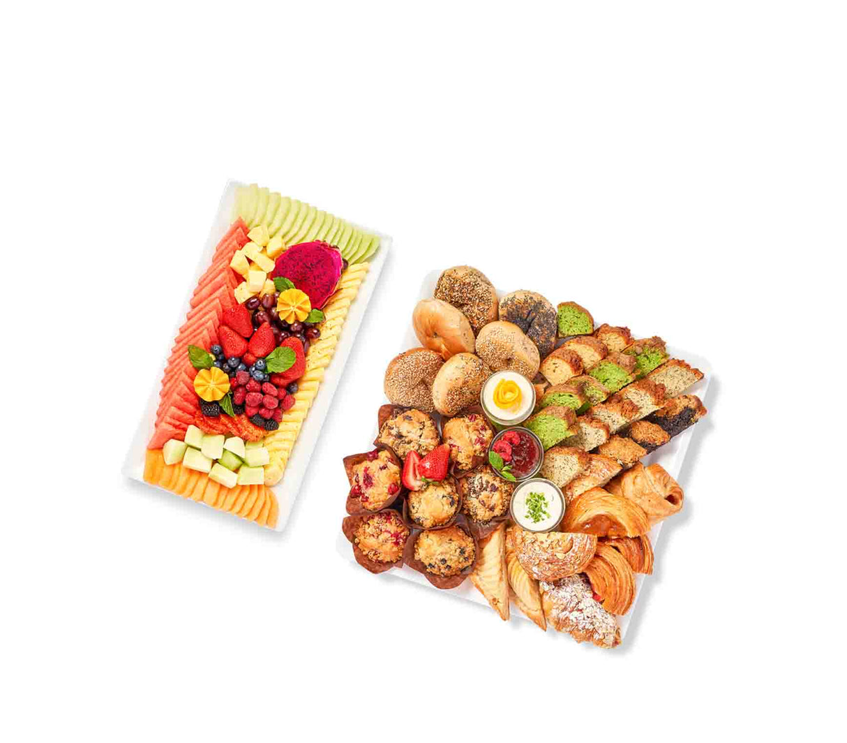 Two trays with fruit and Executive Breakfast pastries on them.