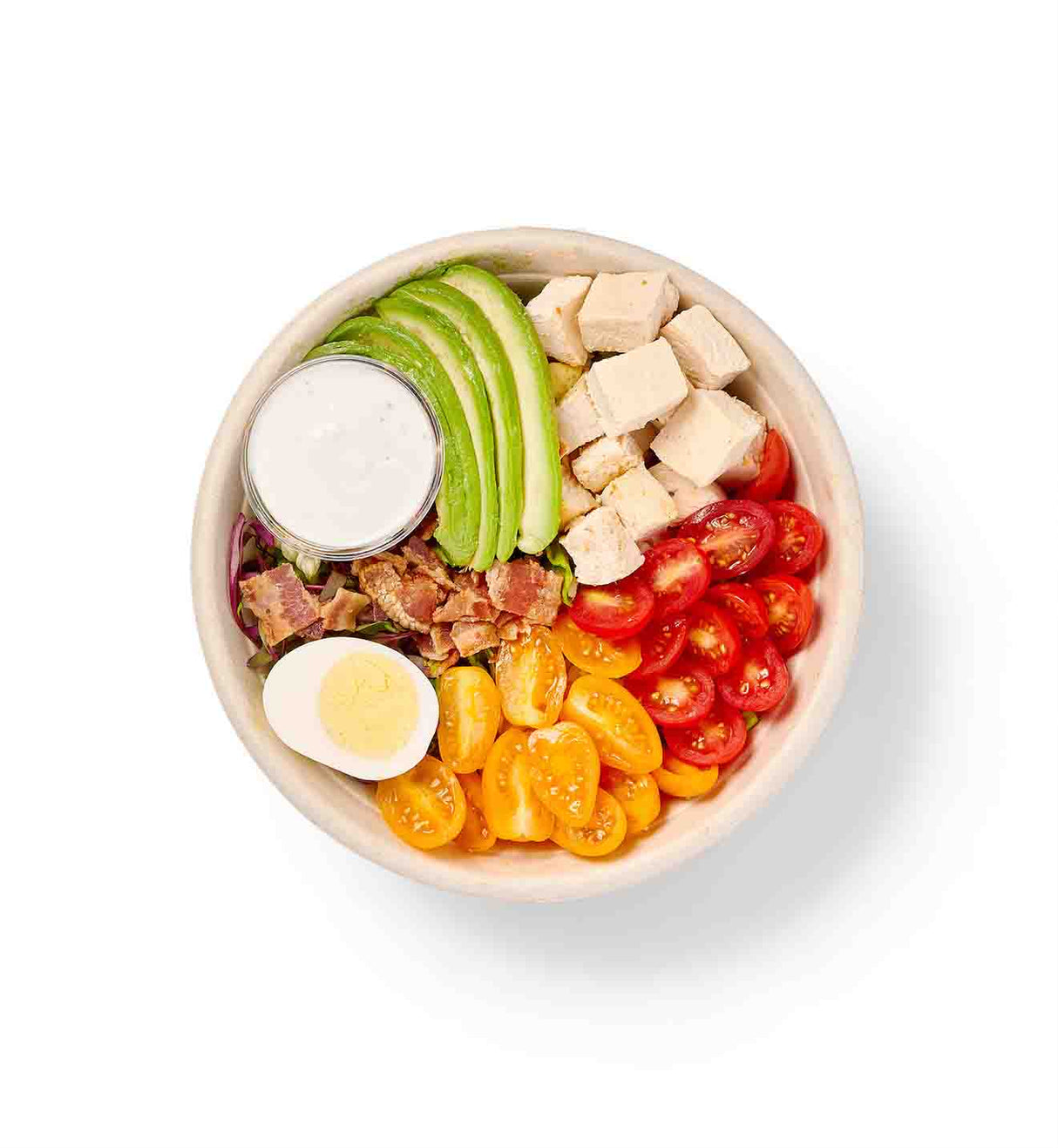 A bowl with Garden Cobb Individual Entree Salad, tomatoes, and crispy bacon.