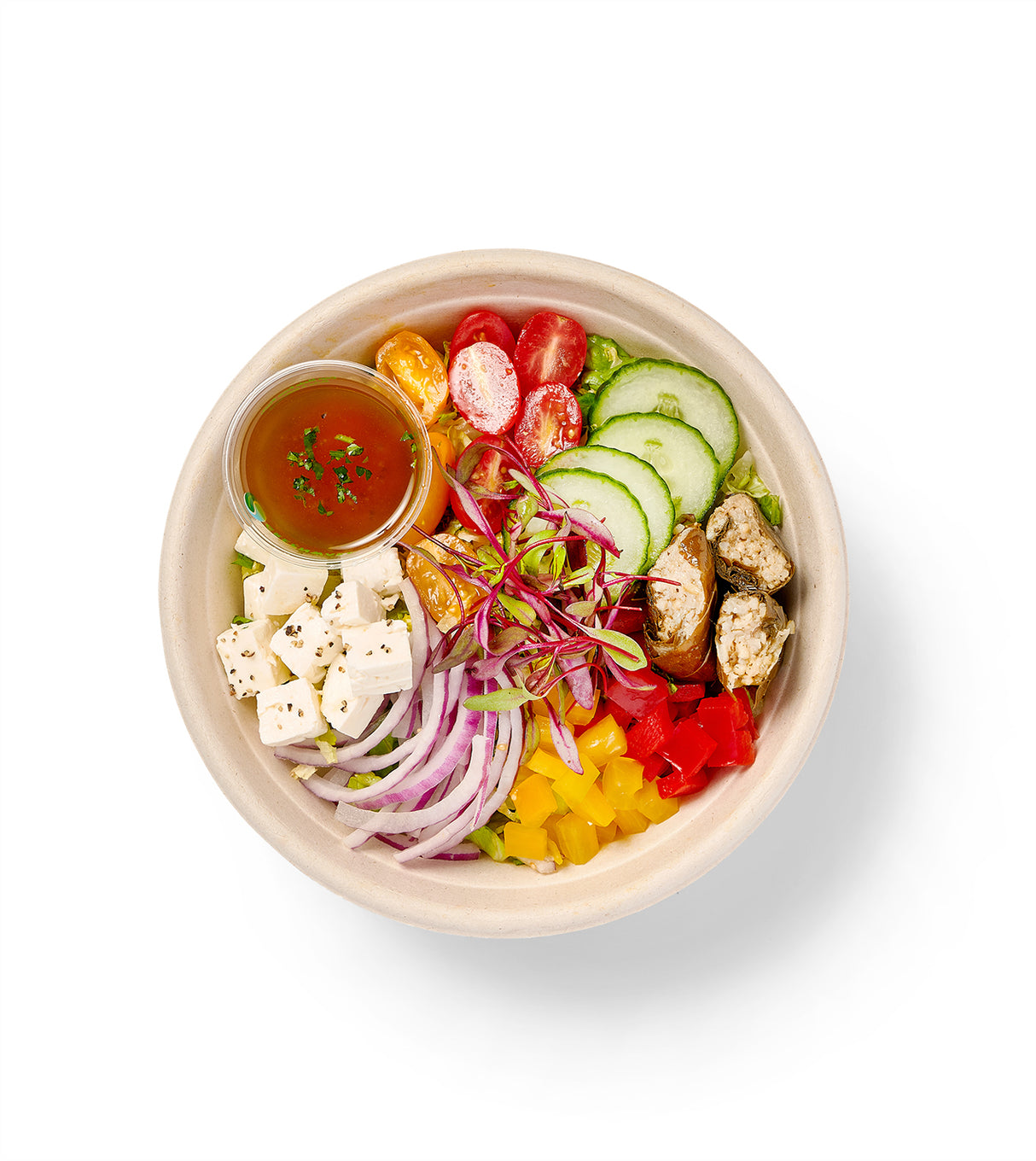 A Greek Individual Entree Salad with a variety of vegetables, including green peppers and romaine hearts.