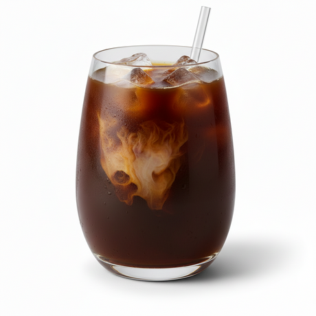A glass of Iced Coffee Service with swirling cream and a straw sits on a white background.