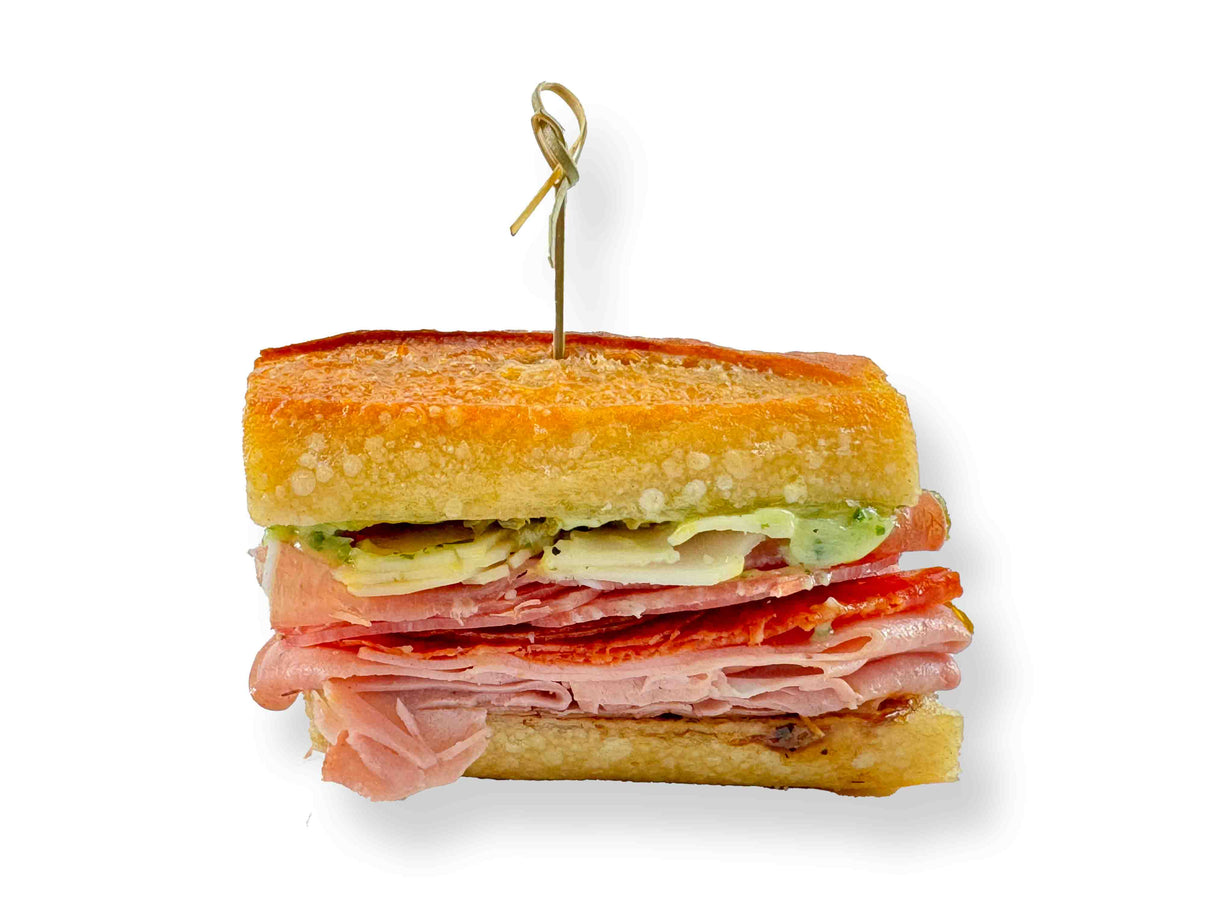 The Classic Italian Mini Sandwich features layers of prosciutto, cheese, and avocado between two slices of bread, all secured with a toothpick.