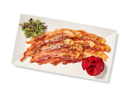 Crispy Bacon on a white plate with a red flower.