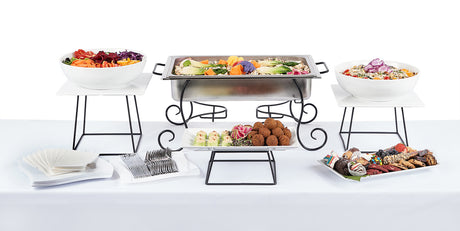 A buffet table with several Middle Eastern Themed Menu selections on it.