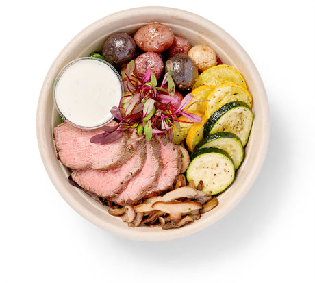 A Herb Seasoned Entree Bowl with vegetables and sauce.