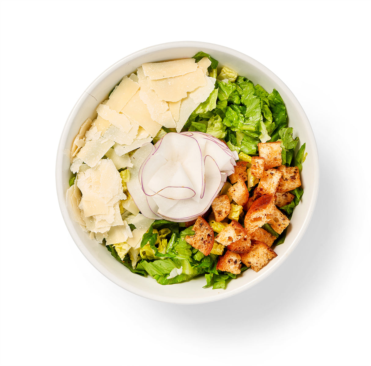 A bowl of Caesar Salad with homemade crouton crumble and shaved parmesan.