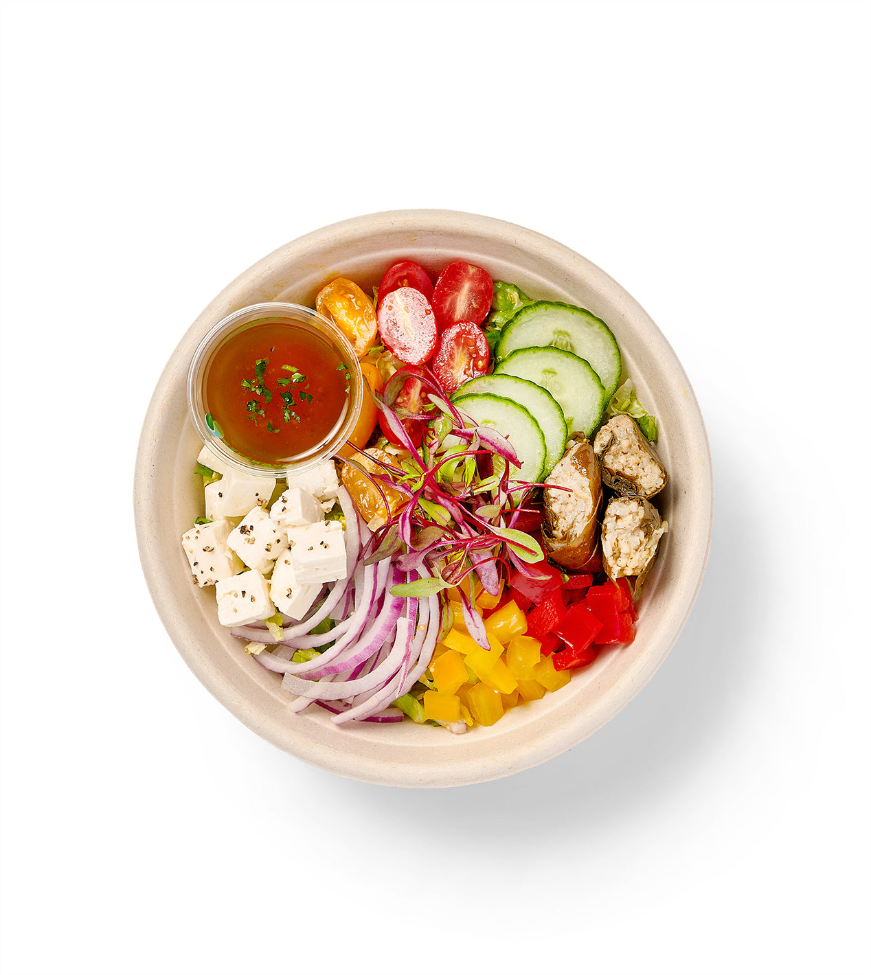 A Greek Individual Entree Salad with a variety of vegetables, including green peppers and romaine hearts.