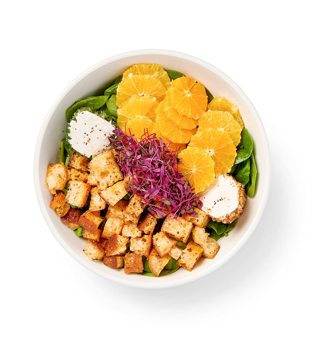 A bowl with Spinach Salad, strawberries, and croutons.